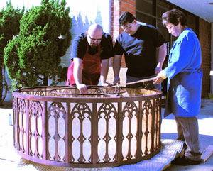 Putting the finishing touches on a large Mica chandelier.